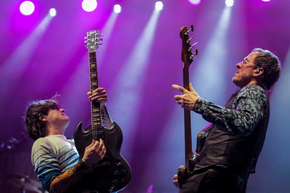 Rivers Cuomo, lead vocals and guitarist, left, and Scott Shriner, bassist, of Weezer play together during the first show of the Weezer x Pixies 2019 tour at the KFC Yum! Center in downtown Louisville, Ky. on Friday, March 8, 2019. 