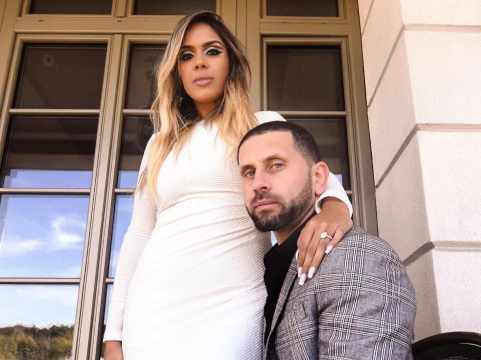 Vishnell and her husband pose for a photo outside