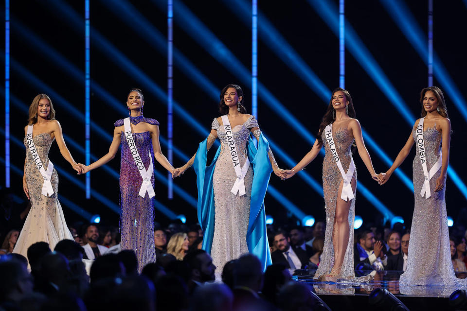 Miss Australia Moraya Wilson, Miss Puerto Rico Karla Guilfú, Miss Nicaragua  Sheynnis Palacios, Miss Thailand Anntonia Porsild and Miss Colombia Maria Avella hold hands during the 72nd Miss Universe Competition at Gimnasio Nacional José Adolfo Pineda on (Hector Vivas / Getty Images)