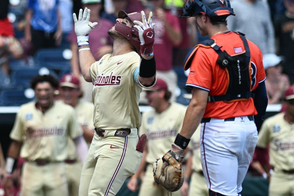 Florida State's Jaime Ferrer (7) celebrates after hitting a home run as Virginia catcher Jacob Ference (28) looks on during the fifth inning at Charles Schwab Field in Omaha, Nebraska on June 16, 2024.