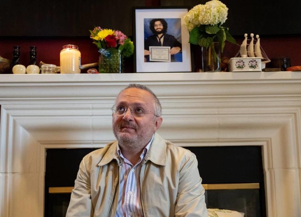 UC Davis professor Majdi Abou Najm looks up Monday, May 1, 2023, toward the bedroom of son Karim Abou Najm, who was fatally stabbed at park in the city over the weekend. A recent photograph of Karim, a UCD student, sits above his father on the fireplace mantel.