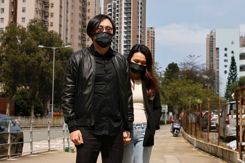 Pro-democracy activist Mike Lam King-nam arrives with his wife to report to the police station over national security law charges