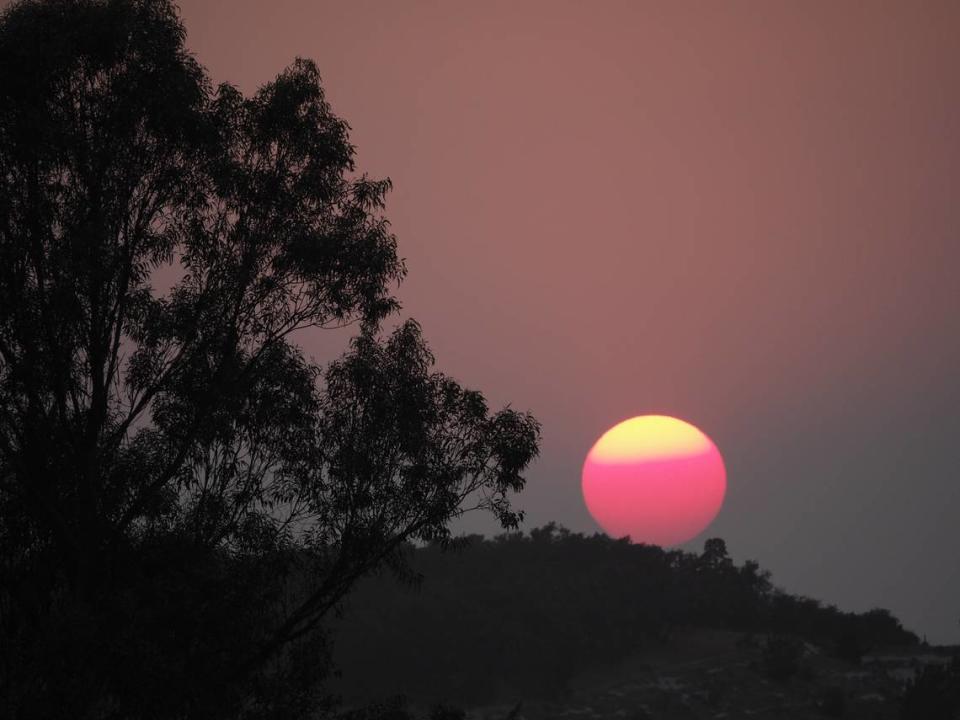 Smoke from wildfires burning in Monterey County turned the setting sun red in 2020 n a view from Oro Drive in Arroyo Grande.