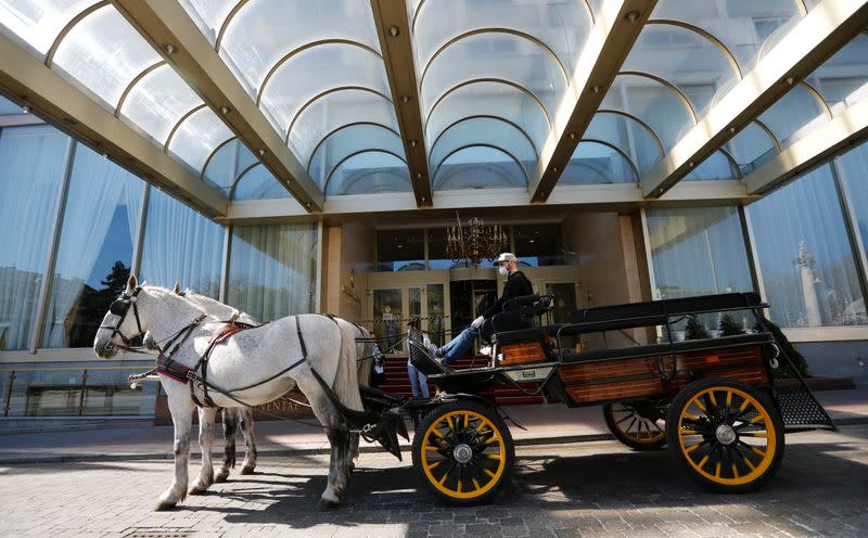 A Fiaker horse carriage waits for food packages in Vienna