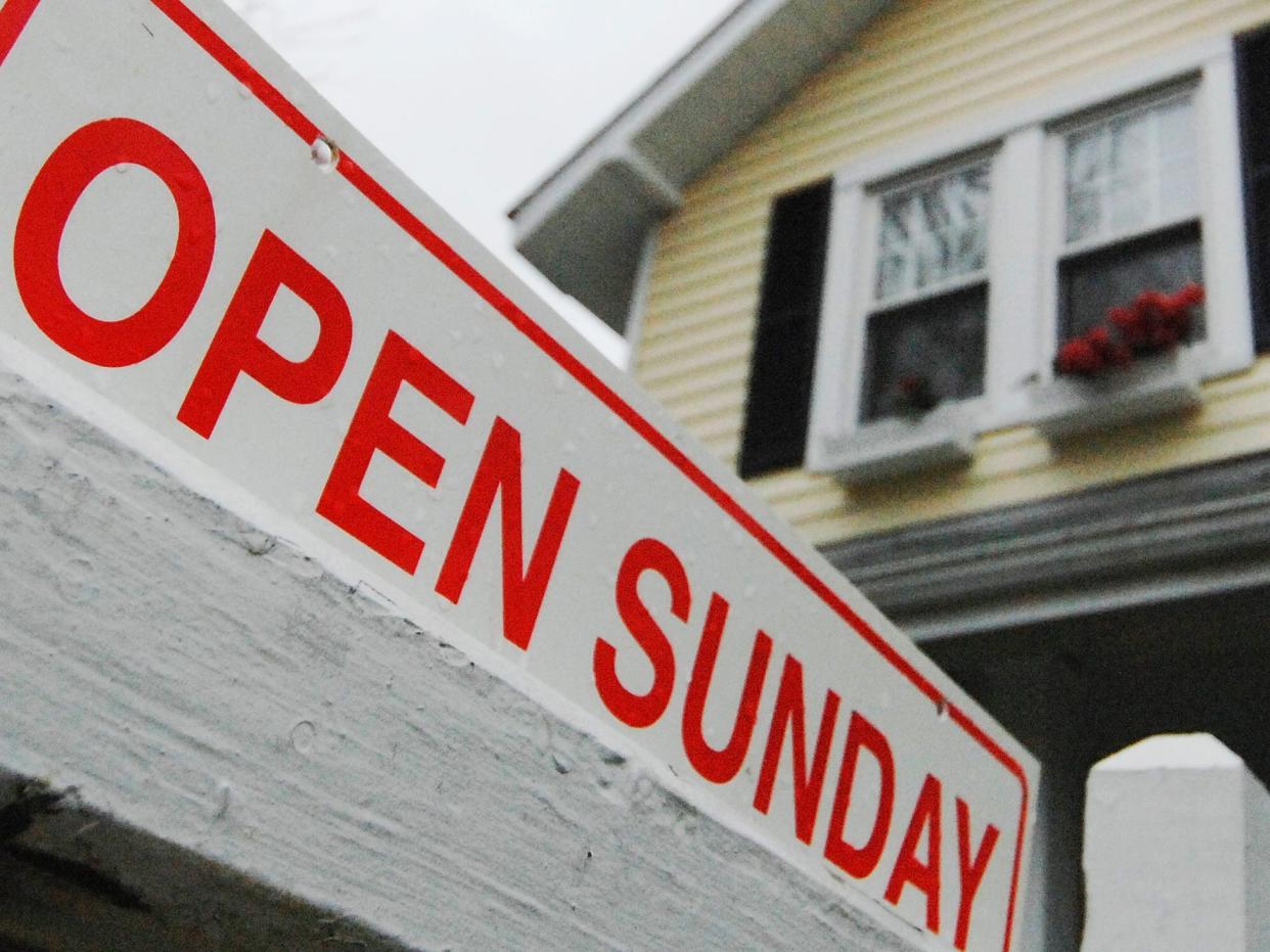 Open house sign in front of house for sale