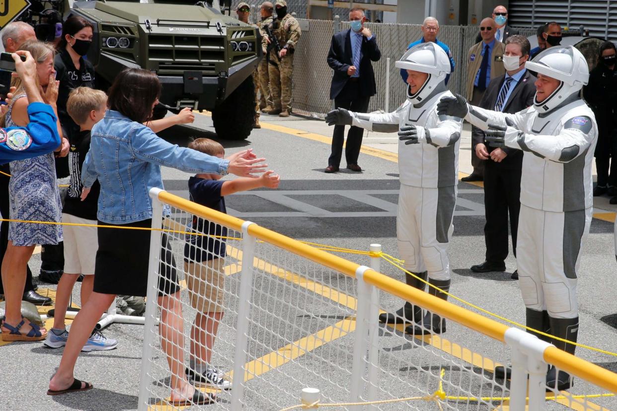 Nasa astronauts Doug Hurley and Bob Behnken greet their families before the launch of a SpaceX Falcon 9 rocket and Crew Dragon spacecraft at the Kennedy Space Center, in Cape Canaveral, Florida: REUTERS