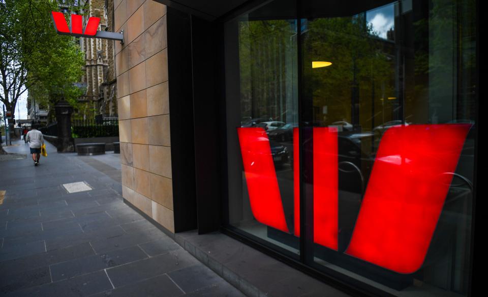 A pedestrian walks past a Westpac bank.