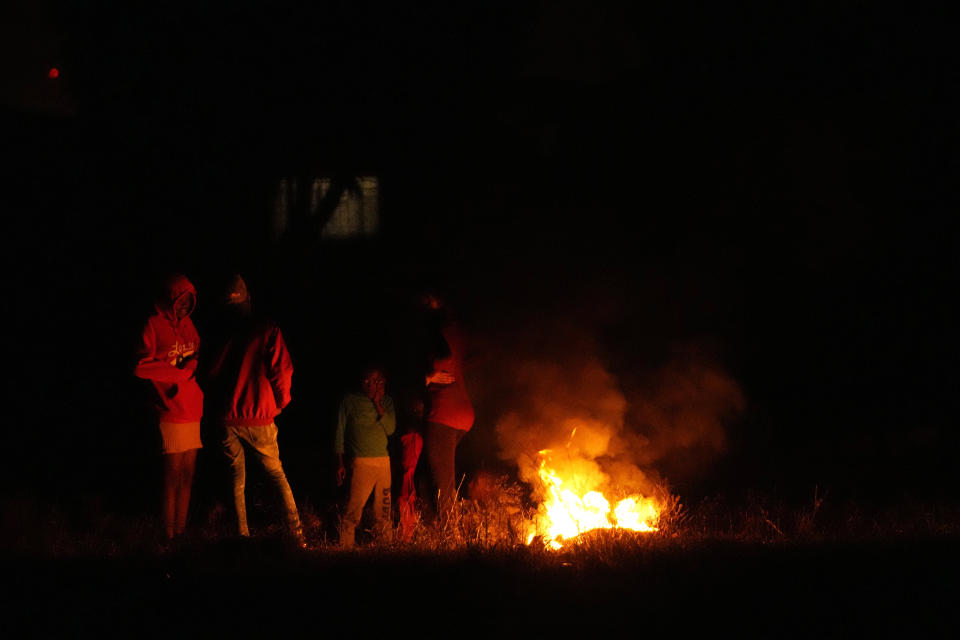 File —Children stand around a fire to keep themselves warm in Hammanskraal, Pretoria, South Africa, Friday, May 26, 2023. Today the ruling African National Congress (ANC) faces growing dissatisfaction from many who feel it has failed to live up to its promises. (AP Photo/Themba Hadebe/File)