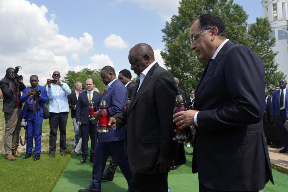 South African President Cyril Ramaphosa, second from right, Senegal's President Macky Sall, centre, and Egypt's Prime Minister Mustafa Madbuly, right, attend a commemoration ceremony at a site of a mass grave in Bucha, on the outskirts of Kyiv, Ukraine, Friday, June 16, 2023. South African President Cyril Ramaphosa arrived in Ukraine on Friday as part of a delegation of African leaders and senior officials seeking ways to end Kyiv's 15-month war with Russia. (AP Photo/Efrem Lukatsky)