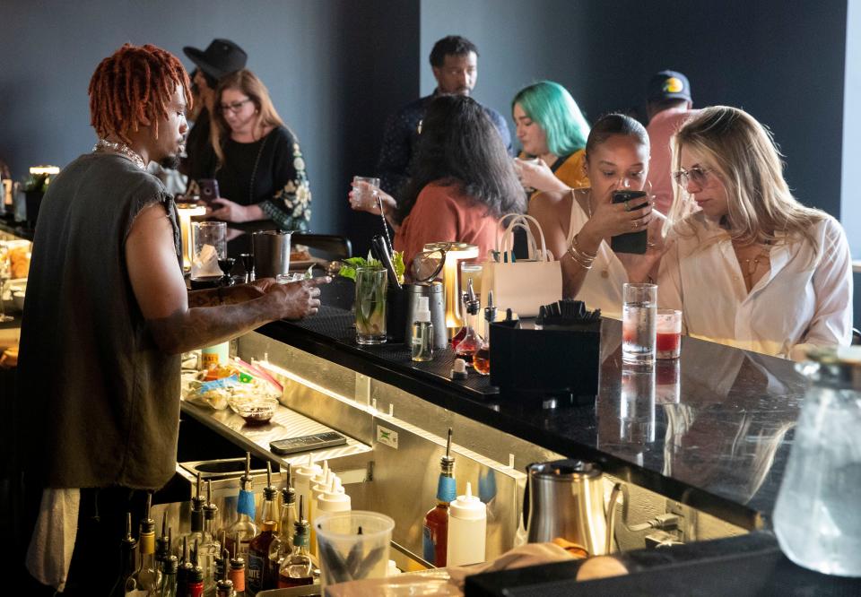 Bartender Jay Booker serves patrons at Inkwell on Wednesday, May 4, 2022, in the Edge District of Memphis.