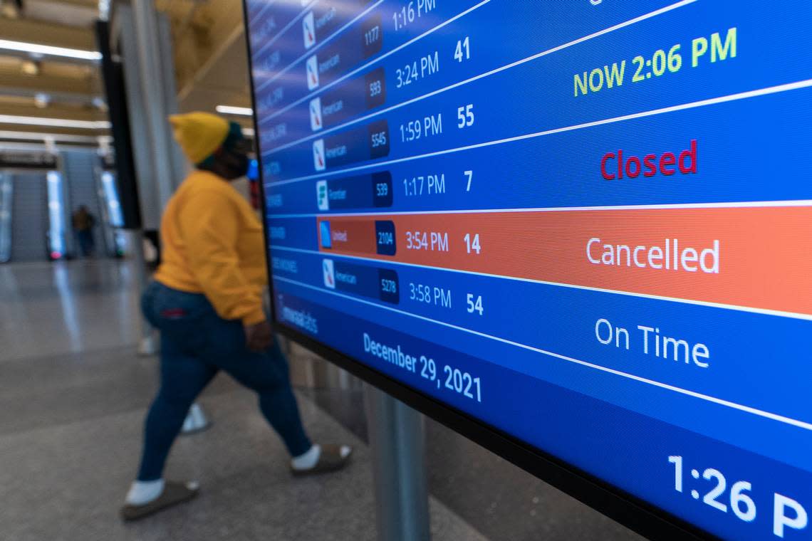 FILE - A flight shows cancelled on the departures board at Ronald Reagan Washington National Airport, Wednesday, Dec. 29, 2021, in Arlington, Va. The Transportation Department is proposing to require airlines to offer passengers a refund if their flight schedule is changed significantly or the airline makes major changes to their itinerary. The proposed rule announced Wednesday, Aug. 3, 2022 would require airlines to give refunds if their departure or arrival time changes by three hours or more for a domestic flight or at least six hours for an international one. (AP Photo/Alex Brandon, File)