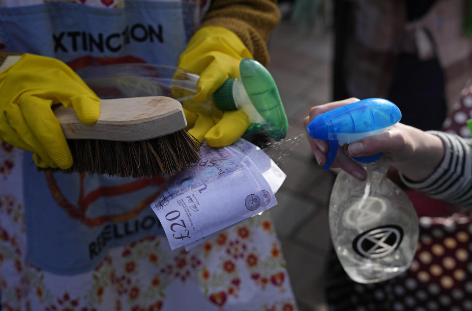 Extension Rebellion activists take part in a demonstration against 'Greenwashing' (an attempt to make people believe that your company or government is doing more to protect the environment than it really is) near the COP26 U.N. Climate Summit in Glasgow, Scotland, Wednesday, Nov. 3, 2021. The U.N. climate summit in Glasgow gathers leaders from around the world, in Scotland's biggest city, to lay out their vision for addressing the common challenge of global warming. (AP Photo/Alastair Grant)