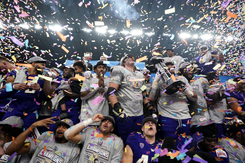 Washington players celebrate their win over Texas in the Alamo Bowl NCAA college football game in San Antonio, Thursday, Dec. 29, 2022. (AP Photo/Eric Gay)