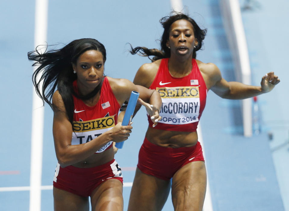 United States' Francena McCorory, right, has handed over the baton to Cassandra Tate to win the women's 4x400m relay final during the Athletics World Indoor Championships in Sopot, Poland, Sunday, March 9, 2014. (AP Photo/Petr David Josek)