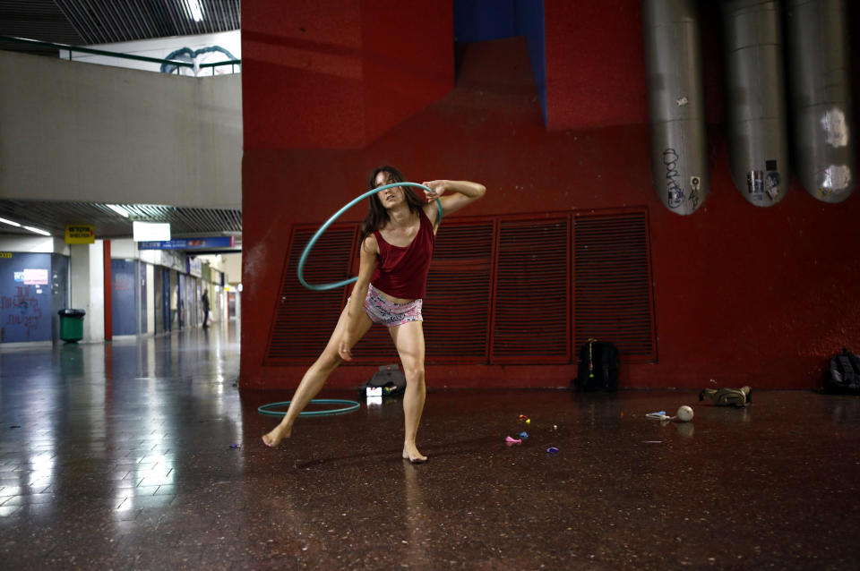 Stav Pinto uses a hula hoop as she practices her acrobatic skills during a weekly informal circus community meeting at the Central Bus Station on July 1. Pinto employs her circus talents to teach life skills to special-needs children.  (Photo: Corinna Kern/Reuters)