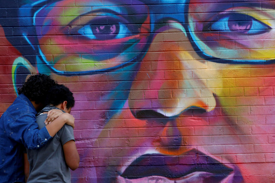 Visitors in Denver pause before a mural of Elijah McClain, before the first anniversary of his death. 