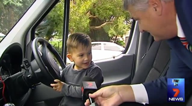 Lawson pretending to drive the ambulance. Photo: 7 News