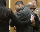 Torrey Green cries while being consoled by defense attorney Skye Lazaro, left, and private investigator E. Christian Warmsley as a jury finds him guilty of eight charges including five counts of rape and a charge sexual battery in connection to reports from six women accusing him of sexual assault while he was a football player at Utah State University, Friday, Jan.18, 2019 in Brigham City, Utah. (Eli Lucero/Herald Journal via AP, Pool)