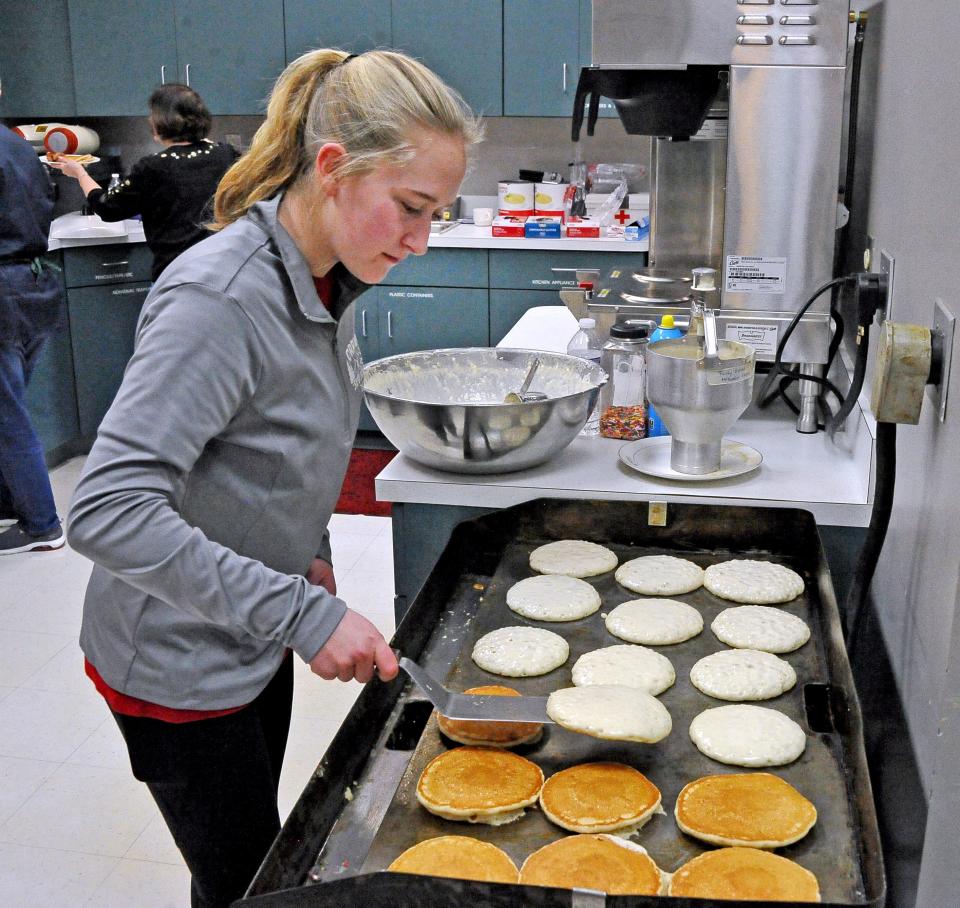 Rachel Anderson is busy flipping pancakes for the Shrove Tuesday meal at the Trinity United Methodist Church in Orrville on Tuesday.
