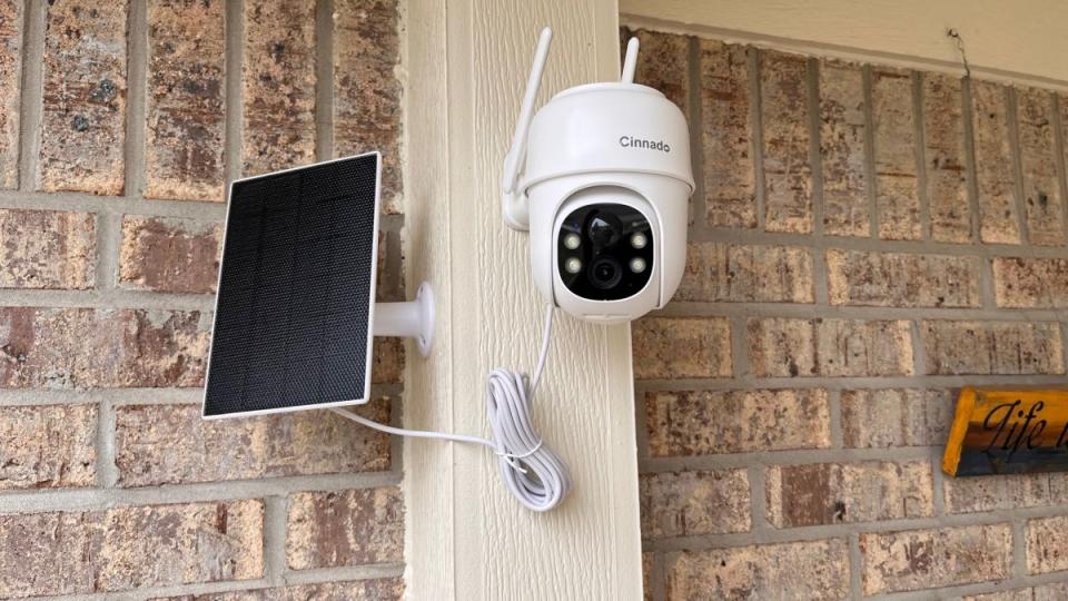 The Cinnado B6 installed on a porch, alongside its solar panel.