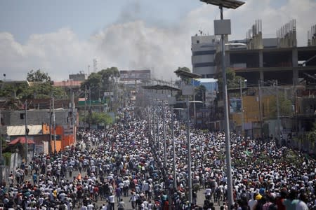 Protesters march during a demonstration called by artists to demand the resignation of Haitian president Jovenel Moise, in the streets of Port-au-Prince