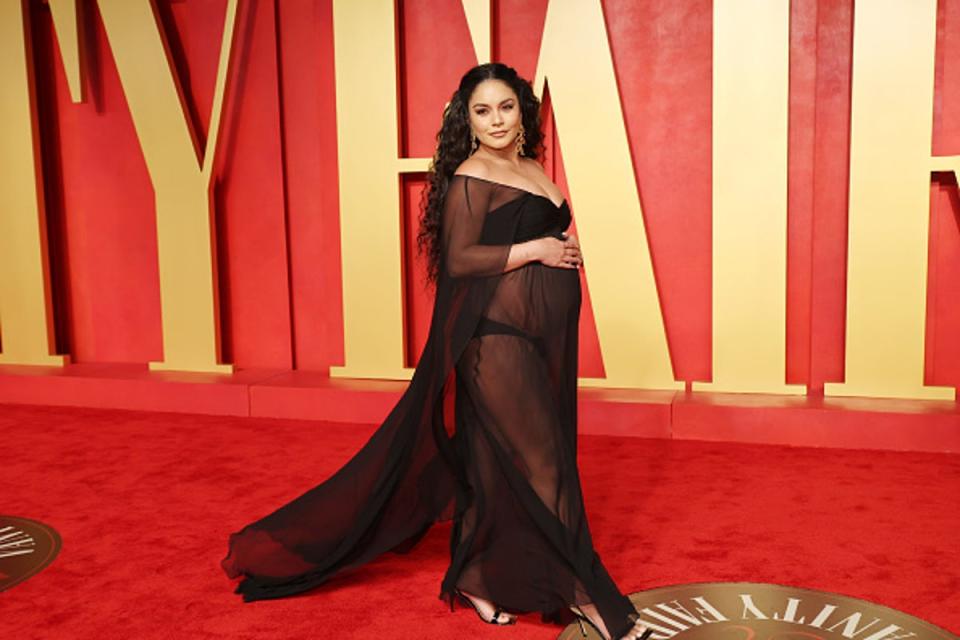 Hudgens photographed cradling her baby bump in March (Getty Images)