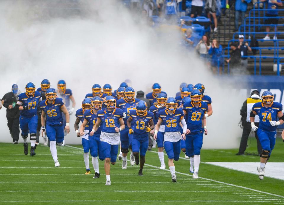 South Dakota State players run onto the field before playing Sam Houston on Sunday, May 16, 2021 in the FCS Championship game at Toyota Stadium in Frisco, Texas.