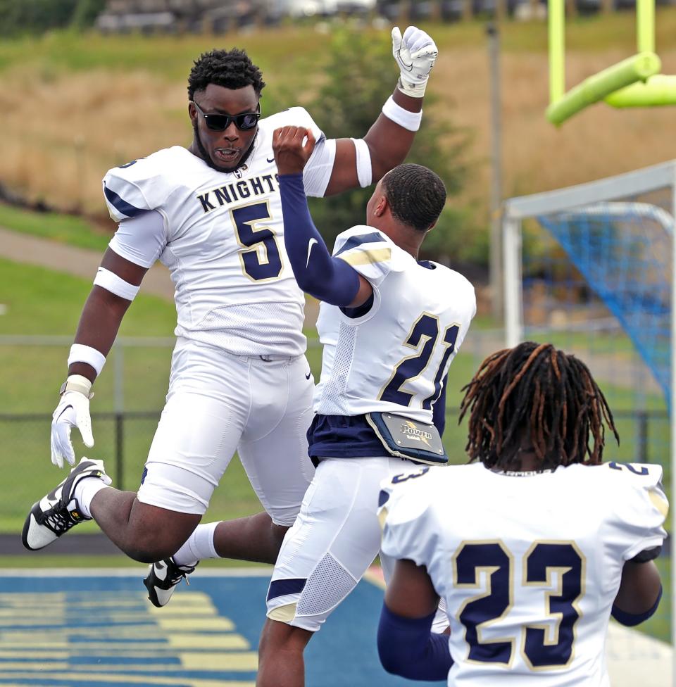 Devin Bell, left, and Ayden Boykin practice celebrating in the end zone during the Hoban football media day, Aug. 7, 2023.