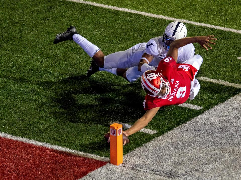 Oct 24, 2020; Bloomington, Indiana, USA;  Indiana Hoosiers quarterback Michael Penix Jr. (9) dives with the ball to score a two point conversion and win the game in overtime during the game at Memorial Stadium. The Indiana Hoosiers defeated the Penn State Nittany Lions 36 to 35.  Mandatory Credit: Marc Lebryk-USA TODAY Sports