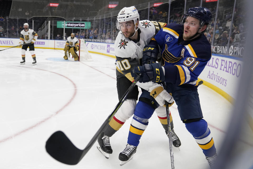 St. Louis Blues' Vladimir Tarasenko, right, gets tangled up with Vegas Golden Knights' Nicolas Roy (10) during the second period of an NHL hockey game Wednesday, April 7, 2021, in St. Louis. (AP Photo/Jeff Roberson)