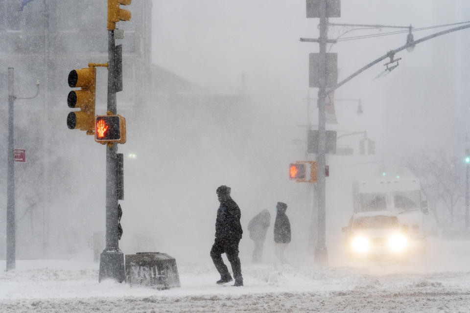 Pedestrians make their way through a snowstorm, Monday, Feb. 1, 2021, in New York. (AP Photo/Mark Lennihan)