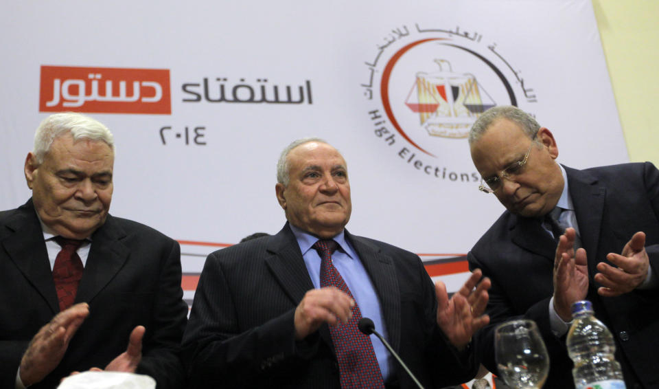 Judge Nabil Salib, head of Egypt's High Election Commission, center, is greeted by other members as he prepares to announce the voting results of a referendum on Egypt's military-backed constitution, in Cairo, Egypt, Saturday, Jan. 18, 2014. Voters overwhelmingly supported Egypt's military-backed constitution in a two-day election, with 98.1 percent supporting it in the first vote since a coup toppled the country's president, the election commission said Saturday. In the lead up to the vote, police arrested those campaigning for a "no" vote on the referendum, leaving little room for arguing against the document. (AP Photo/Amr Nabil)
