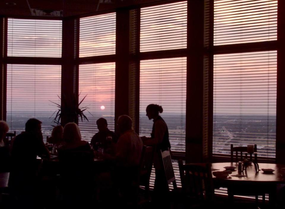 Diners at the original Reata atop The Tower enjoy a gorgeous Texas sunset on August 4, 2000.