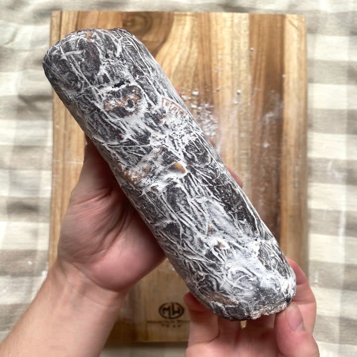 a log of chocolate salami dusted with powdered sugar
