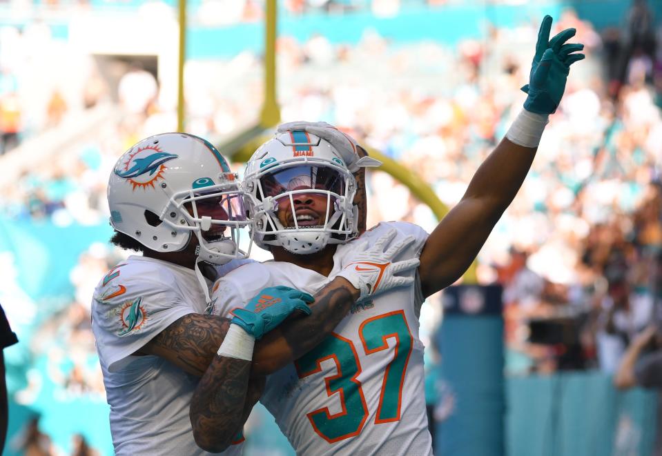 Miami Dolphins running back Myles Gaskin (37) celebrates a touchdown against the Carolina Panthers with teammate wide receiver Albert Wilson (2) during the second quarter of an NFL game at Hard Rock Stadium in Miami Gardens, Nov. 28, 2021. 