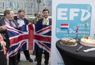 Scottish UKIP member David Coburn, left, holds a Brisith flag as h celebrates the official triggering of Article 50 of the Lisbon Treaty in Brussels on Wednesday, March 29, 2017. EU Council President Donald Tusk has received a letter from British Prime Minister Theresa May, invoking Article 50 of the bloc's key treaty, the formal start of exit negotiations. (AP Photo/Thierry Monasse)