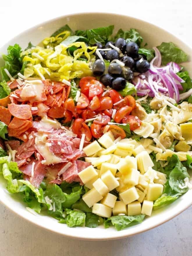 A salad with salami, provolone, artichoke, tomatoes, and more.