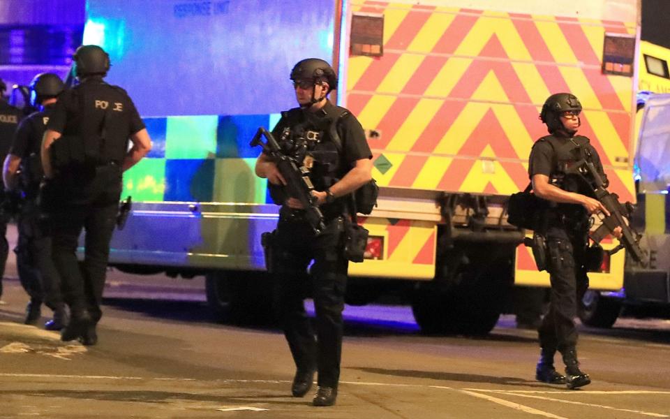 Armed police outside the Manchester Arena on Monday night - Credit: Peter Byrne/PA