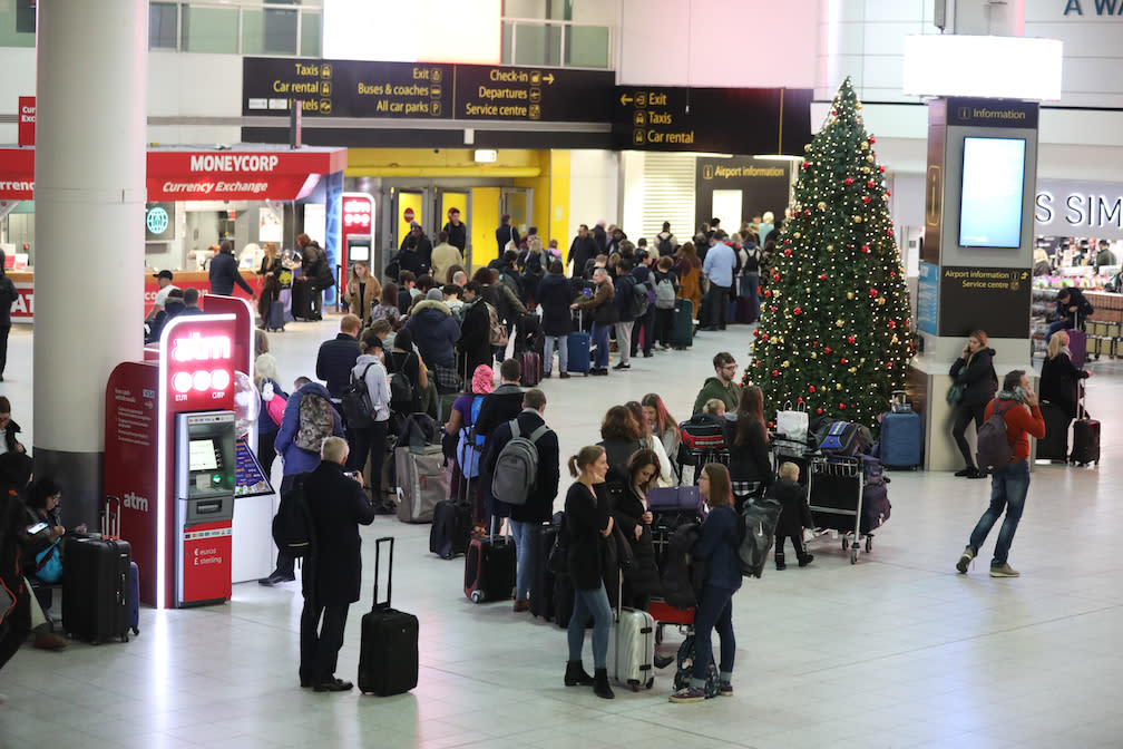 Passengers at Gatwick Airport waiting for their flights following the delays and cancellations brought on by drone sightings near the airfield (Picture: PA)