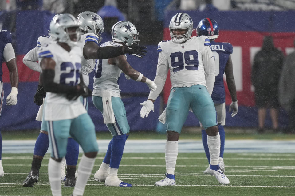 Dallas Cowboys' Chauncey Golston, right, celebrates during the second half of an NFL football game against the New York Giants, Sunday, Sept. 10, 2023, in East Rutherford, N.J. (AP Photo/Bryan Woolston)