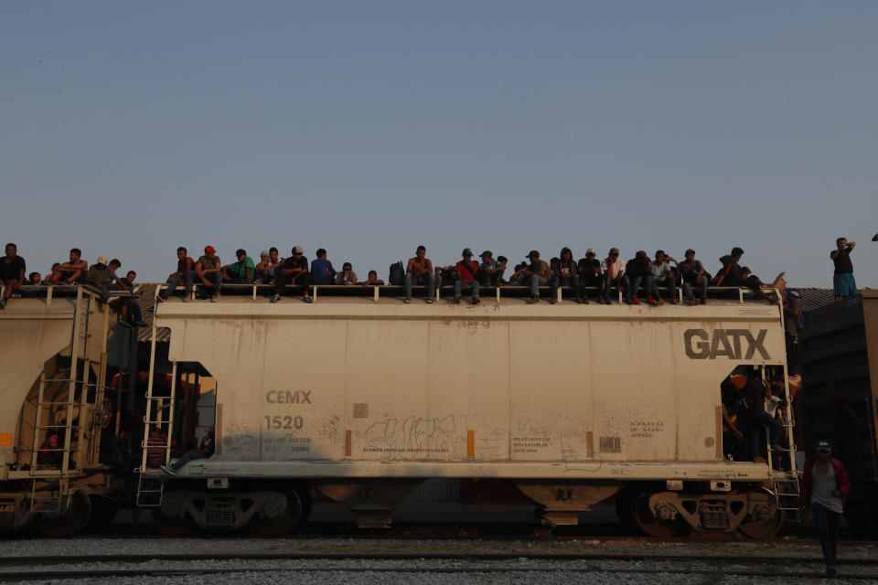 Central American migrants ride atop a freight train during their journey toward the US-Mexico border, in Ixtepec, Oaxaca State, Mexico, Tuesday, April 23, 2019. With dozens of police and immigration checkpoints dotting the highways, many migrants now view the train as a safer, albeit still risky, way to reach the U.S. border. (AP Photo/Moises Castillo)