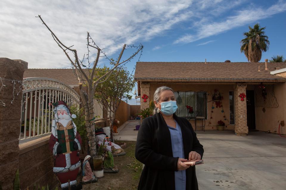 Maria Mendez had to suspend her annual plans of visiting family in her native Mexico after contracting COVID-19. She is photographed outside her home in Mecca as she quarantines in December. 