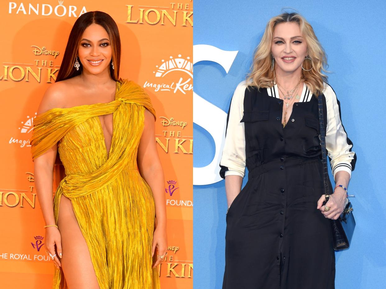 Beyonce in a gold dress in front of an orange "Lion King" backdrop; Madonna in front of a blue backdrop in a black and white jumpsuit