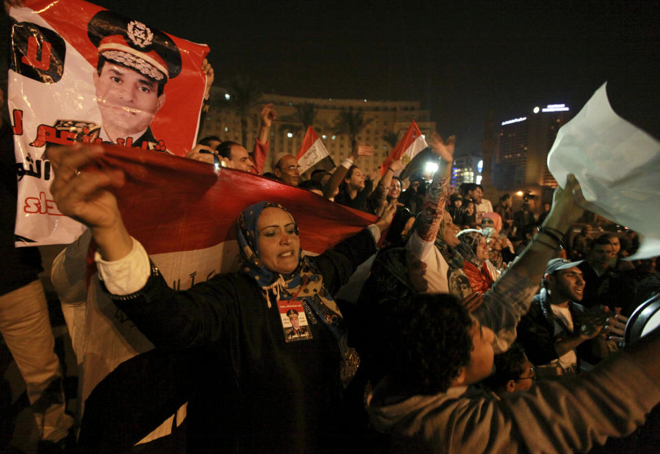 Holding national flags and portraits of military chief Gen. Abdel-Fattah el-Sissi, Egyptians celebrate the passage of a new constitution after 98.1 percent of voters supported Egypt's military-backed constitution in a two-day election, in Tahrir Square, Cairo, Egypt, Saturday, Jan. 18, 2014. In the lead up to the vote, police arrested those campaigning for a "no" vote on the referendum, leaving little room for arguing against the document. (AP Photo/El Shorouk Newspaper, Sabry Khaled) EGYPT OUT