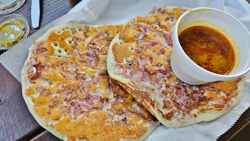 Onion uttapam served with broth from Triveni Supermarket.