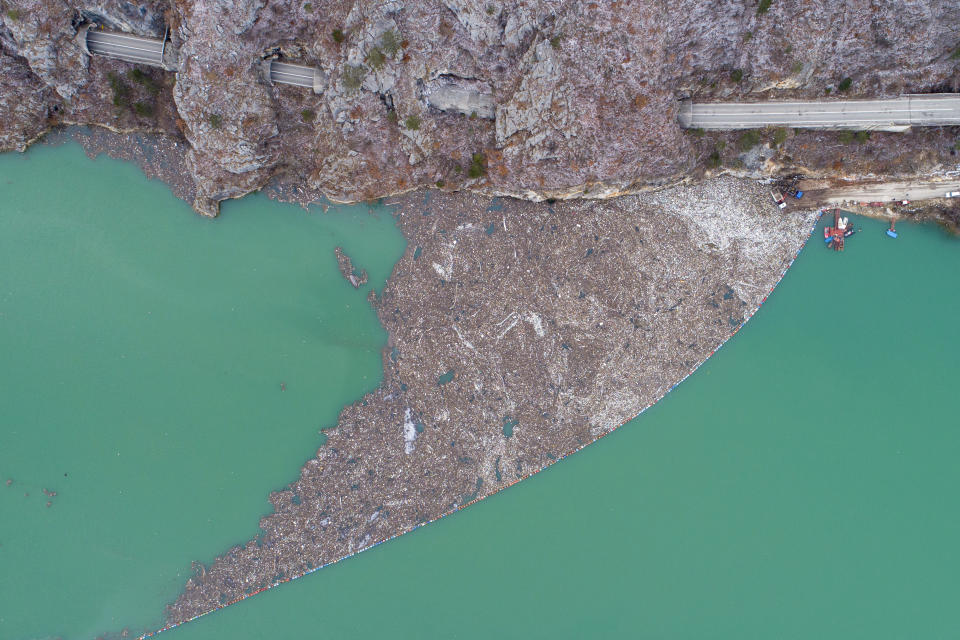 Aerial view of waste floating in the Drina river near Visegrad, Bosnia, Wednesday, Jan. 10, 2024. Tons of waste dumped in poorly regulated riverside landfills or directly into the rivers across three Western Balkan countries end up accumulating during high water season in winter and spring, behind a trash barrier in the Drina River in eastern Bosnia. (AP Photo/Armin Durgut)