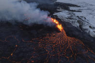 A close up of the Southern active segment of the original fissure of an active volcano in Grindavik on Iceland's Reykjanes Peninsula, Tuesday, Dec. 19, 2023. (AP Photo/Marco Di Marco)