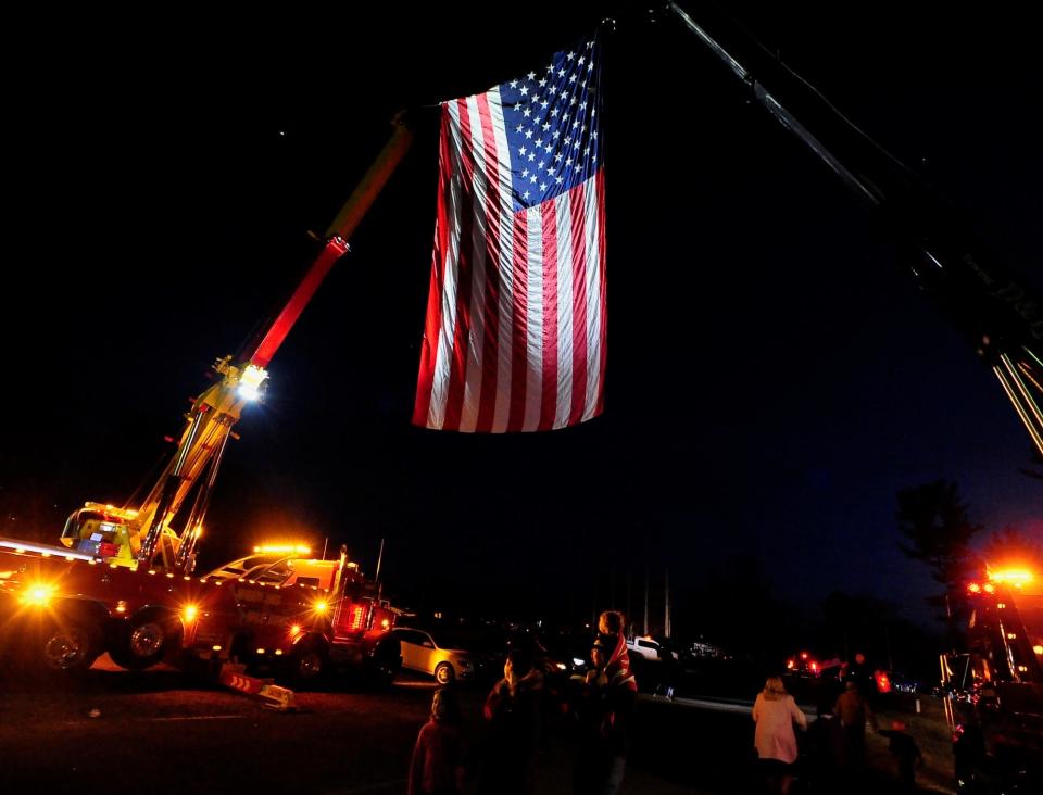 A hoisted American flag welcome truckers in the convoy into the Hagerstown Speedway Friday night.
