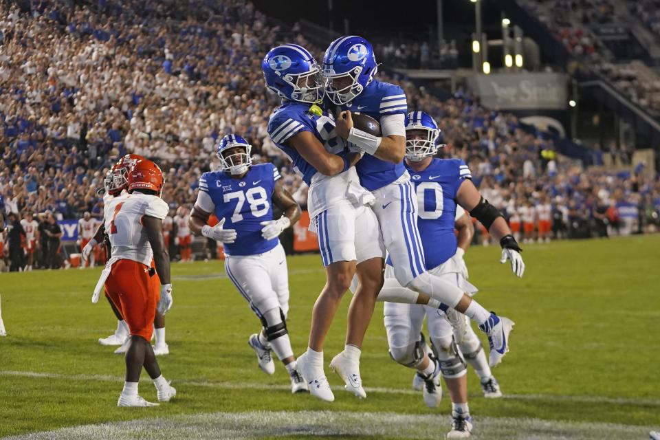 BYU quarterback Kedon Slovis, right, celebrates his touchdown against Sam Houston State with Parker Kingston, left, during the first half of an NCAA college football game Saturday, Sept. 2, 2023, in Provo, Utah. (AP Photo/Rick Bowmer)