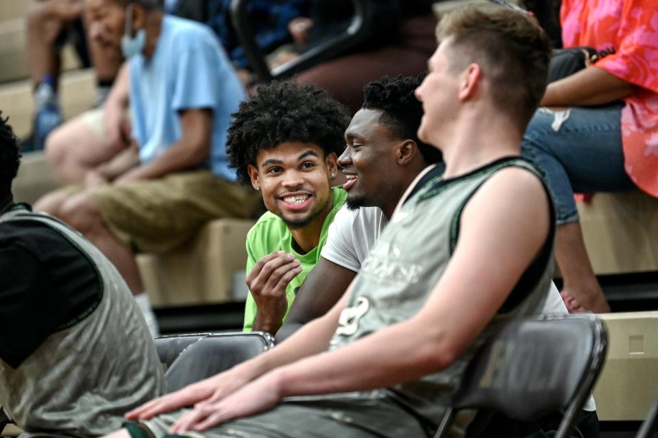 Michigan State's Malik Hall, left, and Mady Sissoko, center, joke with MSU freshman Kohler on Thursday, June 23, 2022, during the Moneyball Pro-Am at Holt High School.